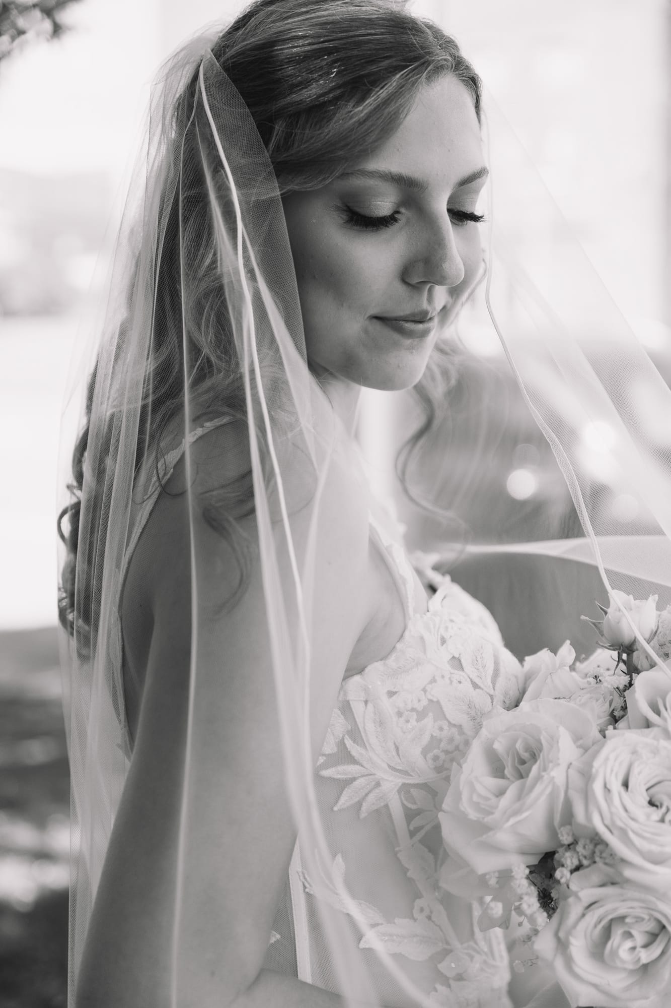 Black-and-white bridal portrait with veil and bouquet