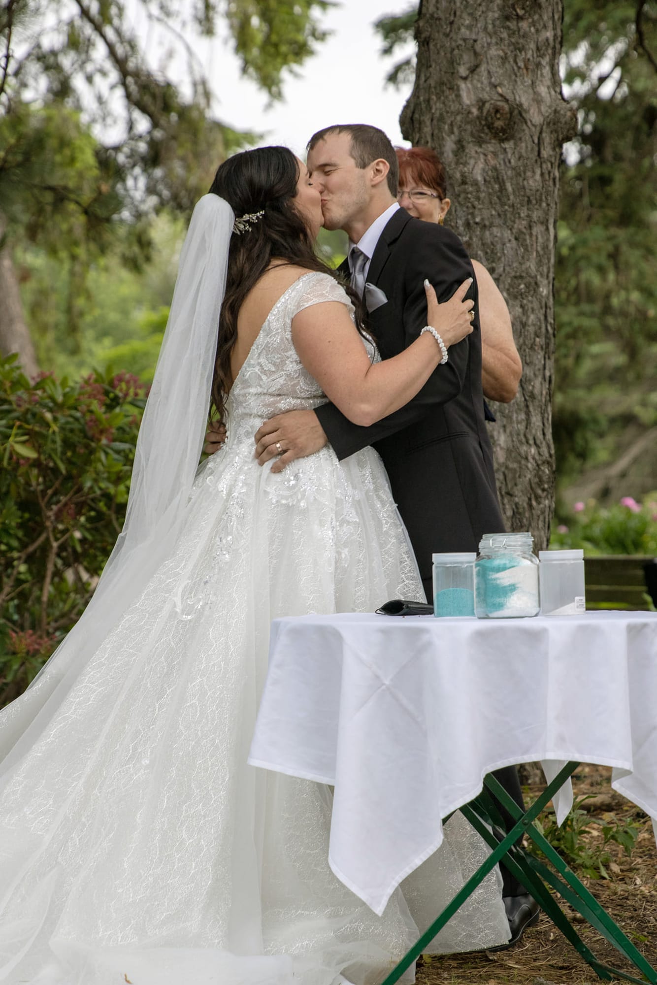 Bride and groom's first kiss at their outdoor ceremony